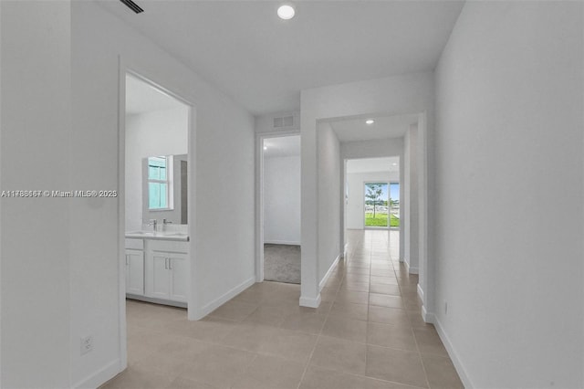 hall featuring visible vents, recessed lighting, baseboards, and light tile patterned flooring