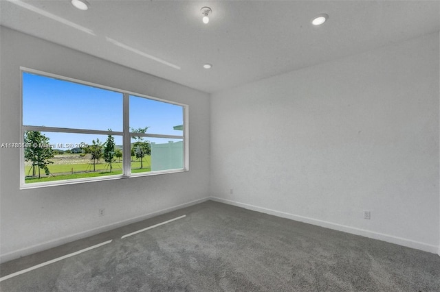 carpeted spare room featuring recessed lighting and baseboards