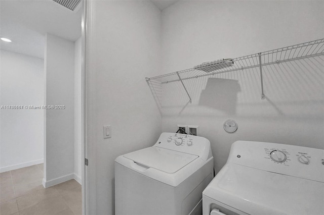 laundry room with laundry area, visible vents, washer and dryer, baseboards, and light tile patterned floors