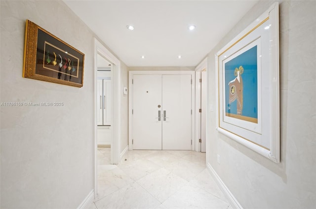 corridor with baseboards, marble finish floor, and recessed lighting