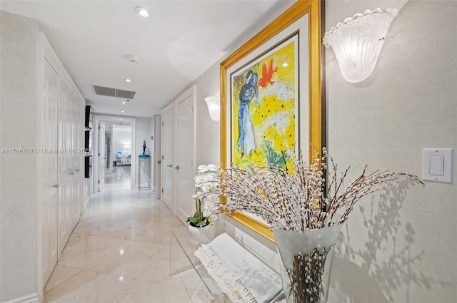 hallway featuring marble finish floor, recessed lighting, and visible vents