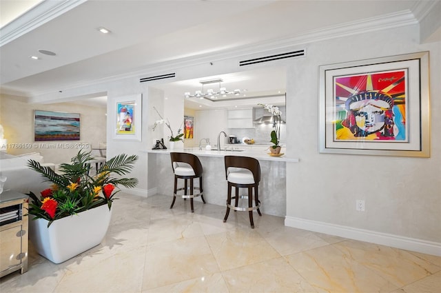 bar with crown molding, baseboards, marble finish floor, and a chandelier