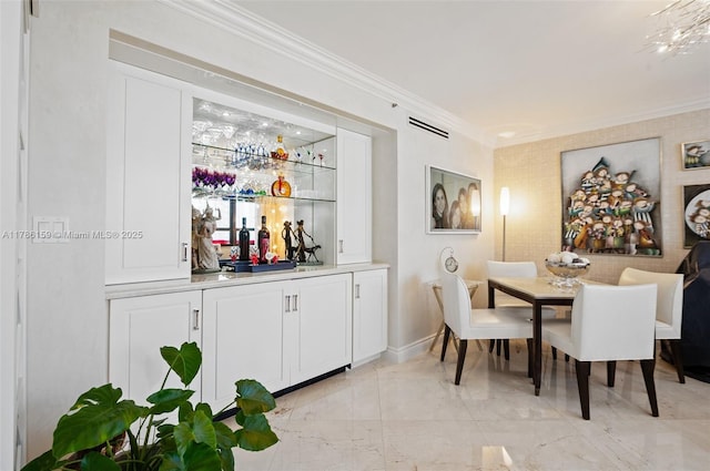 dining room featuring crown molding, visible vents, baseboards, bar area, and marble finish floor