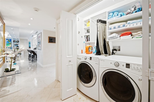 washroom featuring washer and clothes dryer, laundry area, baseboards, and recessed lighting