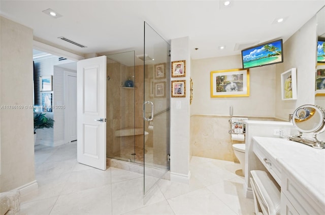 bathroom featuring toilet, vanity, visible vents, tile patterned flooring, and a shower stall
