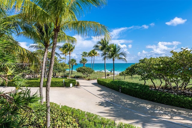 surrounding community featuring a water view and a beach view