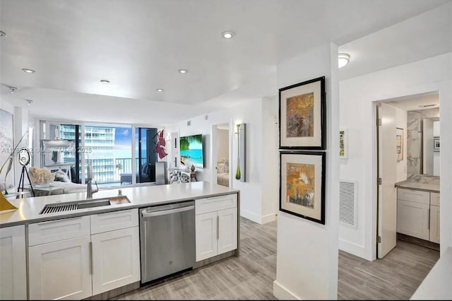 2200 NE 33rd Ave Unit 10F, Fort Lauderdale, FL 33305 - kitchen featuring white cabinets, stainless steel dishwasher, light wood-type flooring, open floor plan, and visible vents