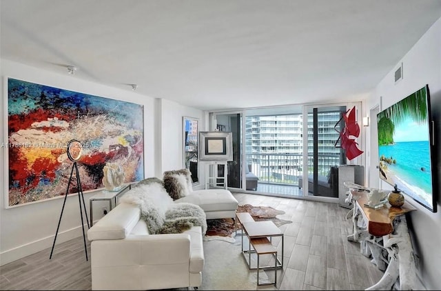 2200 NE 33rd Ave Unit 10F, Fort Lauderdale, FL 33305 - living room with wood finished floors, visible vents, and floor to ceiling windows
