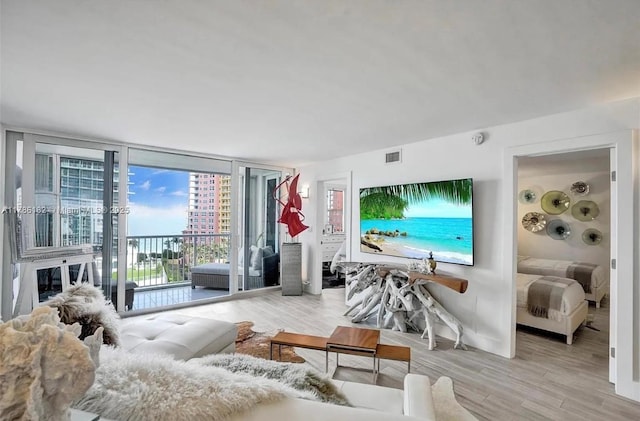 2200 NE 33rd Ave Unit 10F, Fort Lauderdale, FL 33305 - living area featuring wood finished floors, visible vents, and a wall of windows