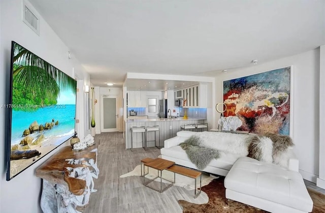 2200 NE 33rd Ave Unit 10F, Fort Lauderdale, FL 33305 - living area with light wood-style flooring and visible vents
