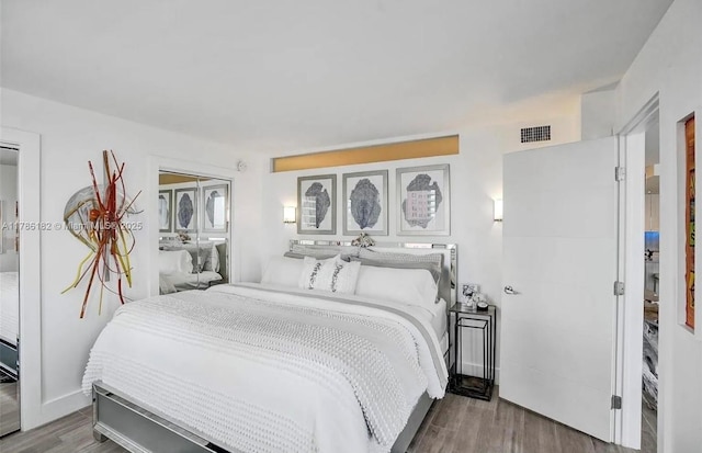 2200 NE 33rd Ave Unit 10F, Fort Lauderdale, FL 33305 - bedroom featuring wood finished floors and visible vents