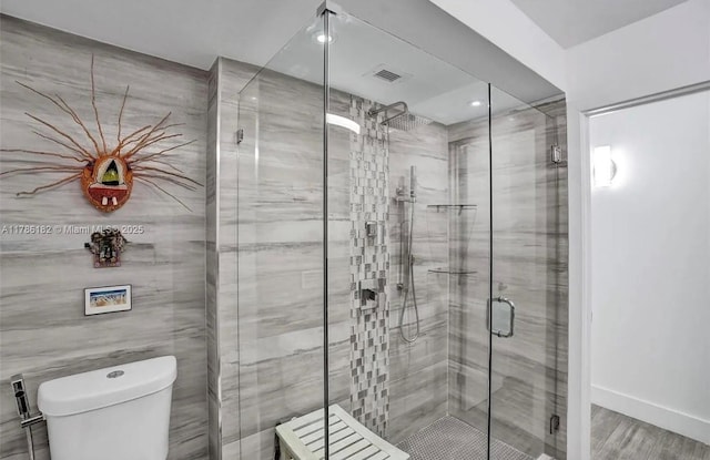 2200 NE 33rd Ave Unit 10F, Fort Lauderdale, FL 33305 - bathroom featuring wood finished floors, a stall shower, toilet, visible vents, and recessed lighting