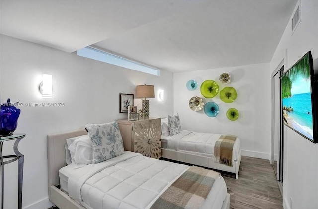 2200 NE 33rd Ave Unit 10F, Fort Lauderdale, FL 33305 - bedroom with wood finished floors, visible vents, and baseboards