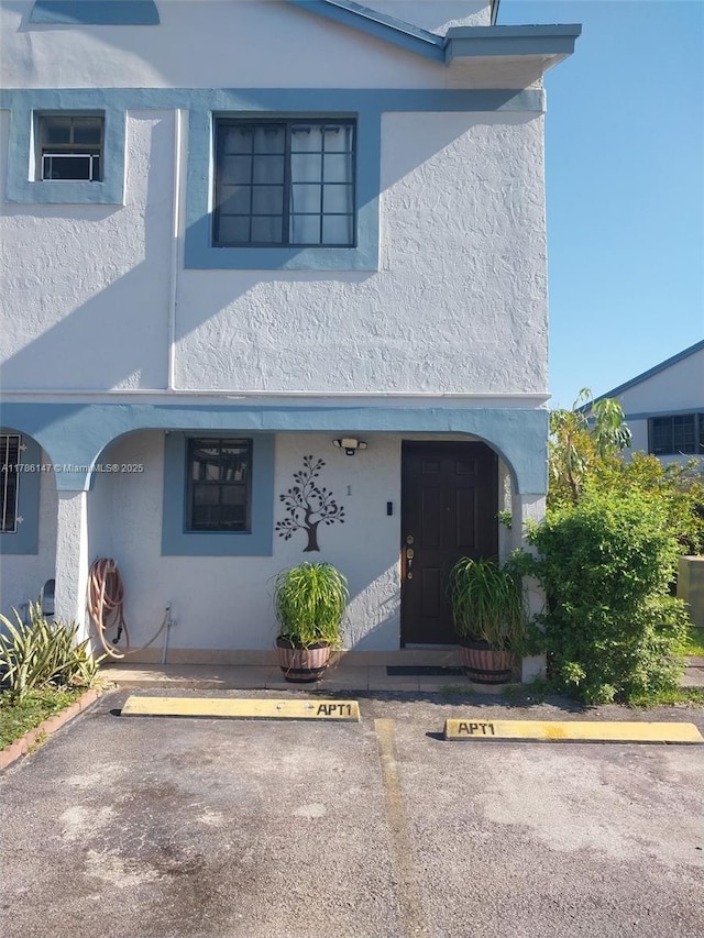 12045 SW 18th St Unit 1-42, Miami, FL 33175 - view of front facade with stucco siding and uncovered parking