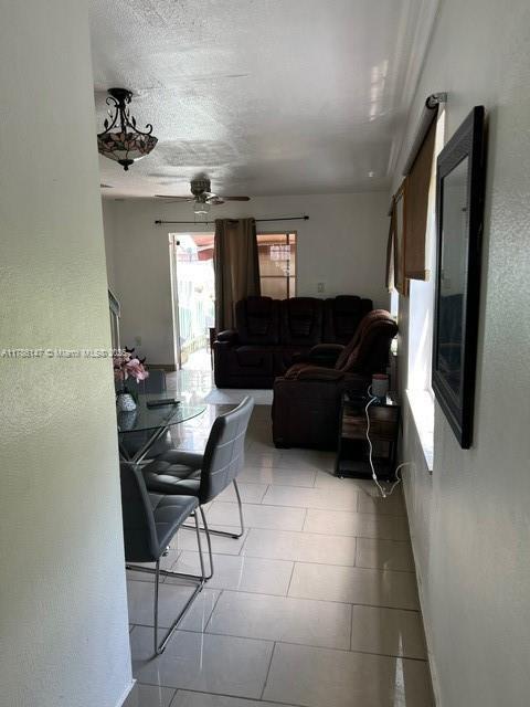 12045 SW 18th St Unit 1-42, Miami, FL 33175 - living area featuring a ceiling fan, a textured ceiling, and tile patterned floors