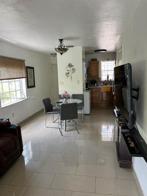 12045 SW 18th St Unit 1-42, Miami, FL 33175 - living area featuring a textured ceiling and light tile patterned flooring
