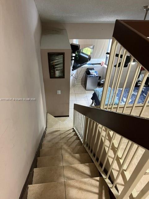12045 SW 18th St Unit 1-42, Miami, FL 33175 - stairs with a textured ceiling