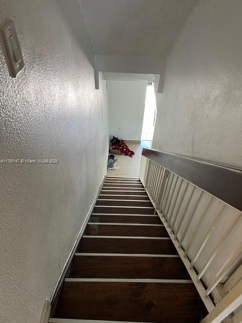 12045 SW 18th St Unit 1-42, Miami, FL 33175 - stairs with hardwood / wood-style floors and a textured wall
