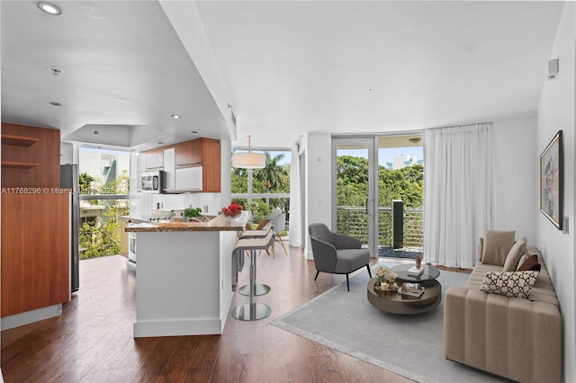 110 Washington Ave Unit 2307, Miami Beach, FL 33139 - living room with floor to ceiling windows, wood finished floors, and recessed lighting