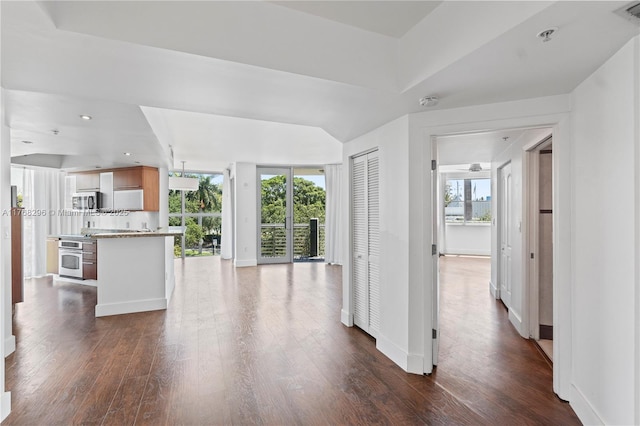 110 Washington Ave Unit 2307, Miami Beach, FL 33139 - unfurnished living room with dark wood-type flooring and baseboards
