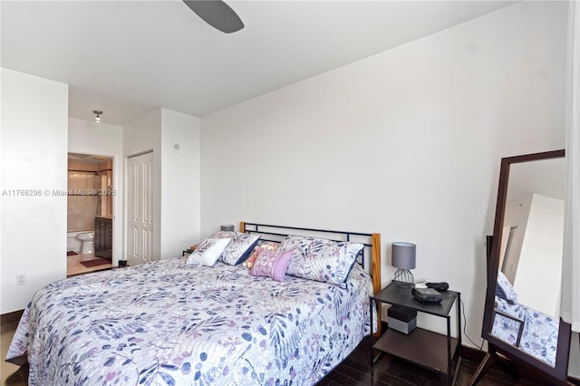 bedroom featuring wood finished floors, ensuite bath, and a ceiling fan