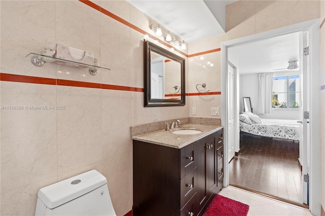 110 Washington Ave Unit 2307, Miami Beach, FL 33139 - half bath with vanity, tile walls, ensuite bath, and tile patterned floors