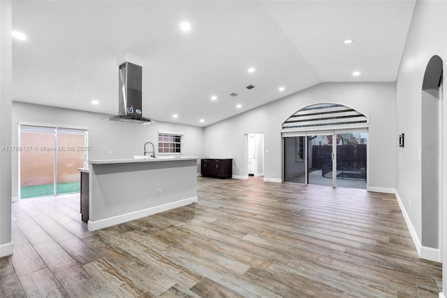 8612 SW 159th Pl, Miami, FL 33193 - kitchen with ventilation hood, arched walkways, an island with sink, healthy amount of natural light, and recessed lighting