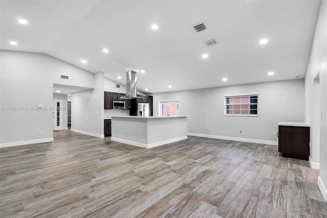 8612 SW 159th Pl, Miami, FL 33193 - unfurnished living room featuring light wood finished floors, vaulted ceiling, and recessed lighting