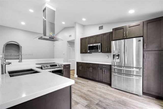 8612 SW 159th Pl, Miami, FL 33193 - kitchen with appliances with stainless steel finishes, island exhaust hood, vaulted ceiling, light countertops, and dark brown cabinetry
