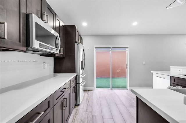 8612 SW 159th Pl, Miami, FL 33193 - kitchen with appliances with stainless steel finishes, light countertops, recessed lighting, light wood-style floors, and dark brown cabinetry