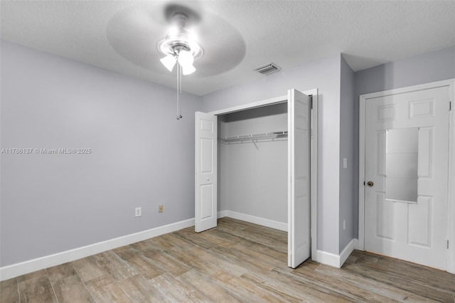 8612 SW 159th Pl, Miami, FL 33193 - unfurnished bedroom featuring wood finished floors, a textured ceiling, a closet, and ceiling fan
