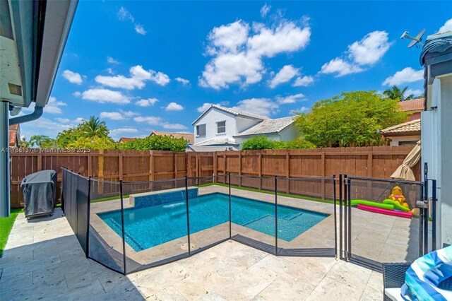 8612 SW 159th Pl, Miami, FL 33193 - view of pool featuring a patio, a fenced backyard, and a grill