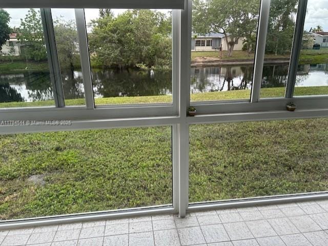 unfurnished sunroom with a water view