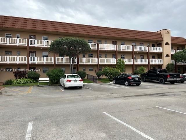 view of building exterior featuring uncovered parking