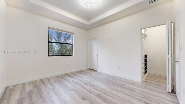 9231 W 32nd Ln, Hialeah, FL 33018 - empty room with light wood-style flooring and a tray ceiling