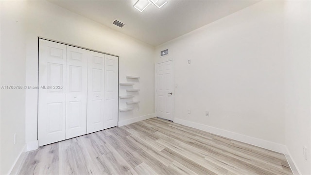 9231 W 32nd Ln, Hialeah, FL 33018 - unfurnished bedroom featuring light wood-style floors and a closet