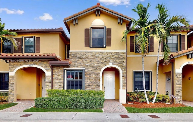 9231 W 32nd Ln, Hialeah, FL 33018 - view of front of house featuring stone siding, stucco siding, and a tiled roof