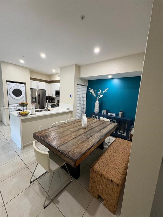 7340 NW 114th Ave Unit 201, Doral, FL 33178 - dining space featuring stacked washer / dryer, light tile patterned floors, and recessed lighting