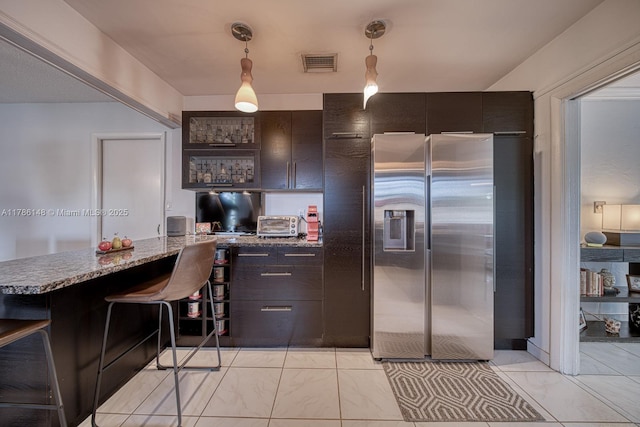 7215 SW 16th St, Miami, FL 33155 - kitchen featuring stainless steel fridge with ice dispenser, built in desk, dark brown cabinets, visible vents, and a peninsula