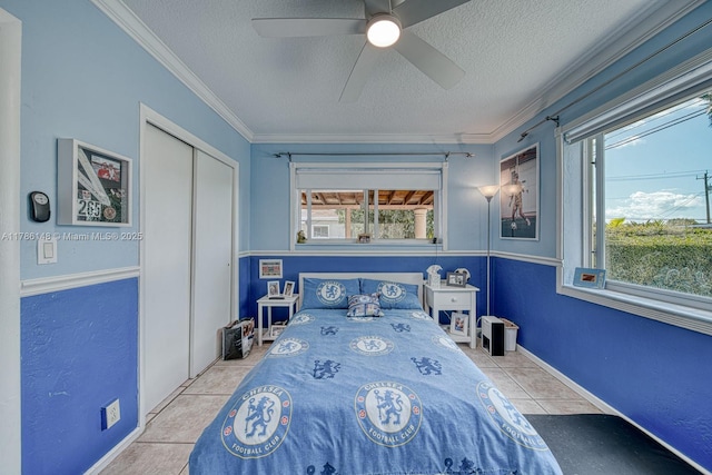 7215 SW 16th St, Miami, FL 33155 - bedroom featuring tile patterned floors, a textured ceiling, multiple windows, and a closet