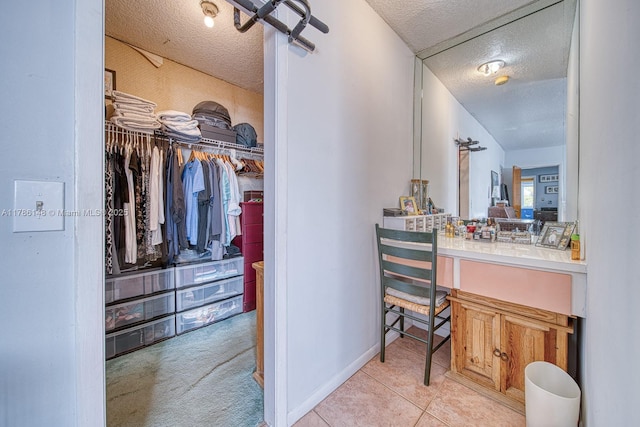 7215 SW 16th St, Miami, FL 33155 - bathroom with a textured ceiling, a walk in closet, vanity, and baseboards