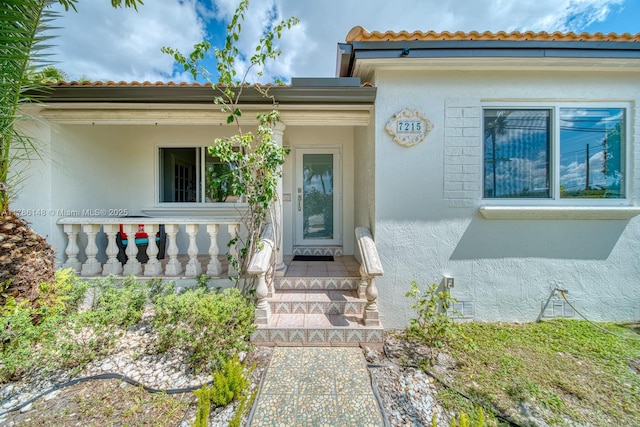 7215 SW 16th St, Miami, FL 33155 - view of exterior entry with a tile roof and stucco siding