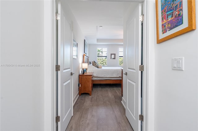 hall featuring dark wood finished floors and baseboards