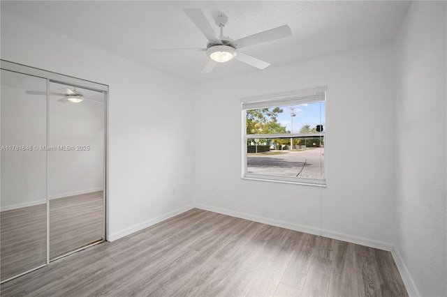 244 NW 179th St, Miami Gardens, FL 33169 - unfurnished bedroom featuring baseboards, a ceiling fan, wood finished floors, and a closet