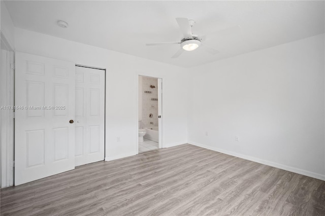 244 NW 179th St, Miami Gardens, FL 33169 - unfurnished bedroom featuring light wood-type flooring, ensuite bathroom, baseboards, a closet, and ceiling fan