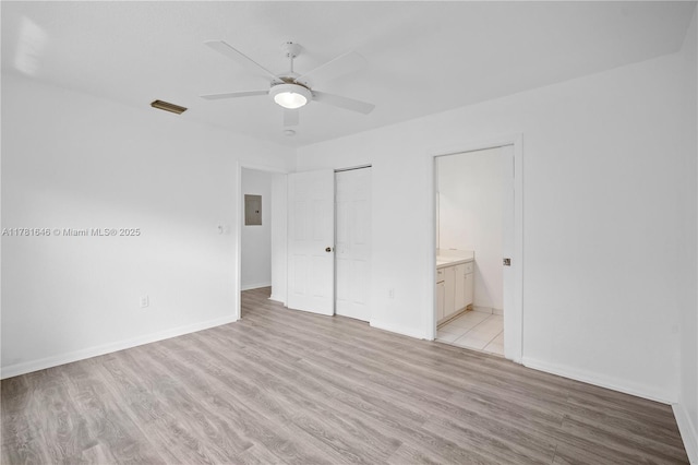 244 NW 179th St, Miami Gardens, FL 33169 - unfurnished bedroom featuring electric panel, light wood-style flooring, visible vents, baseboards, and ensuite bath