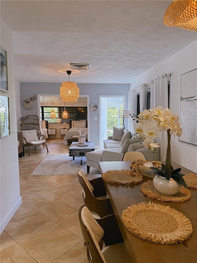 living area featuring visible vents and light tile patterned flooring
