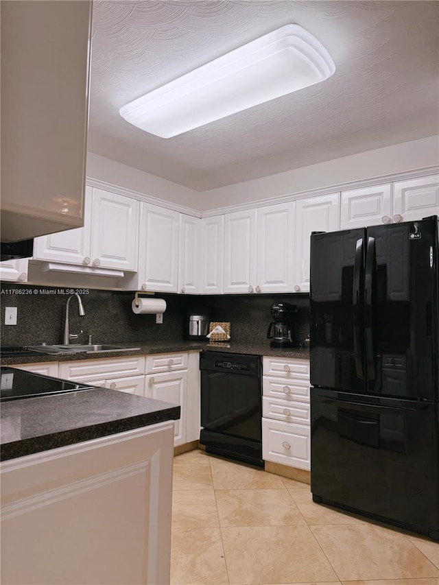 kitchen with dark countertops, white cabinetry, a sink, backsplash, and black appliances