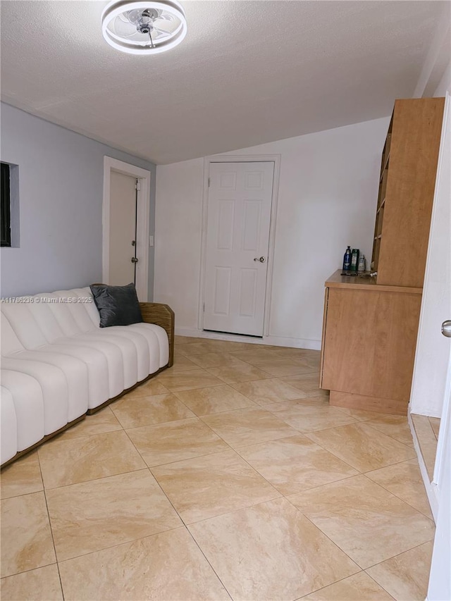 living room featuring a textured ceiling and light tile patterned flooring
