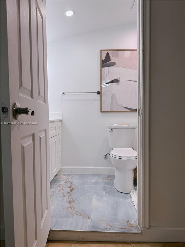 full bathroom with baseboards, vanity, toilet, marble finish floor, and recessed lighting